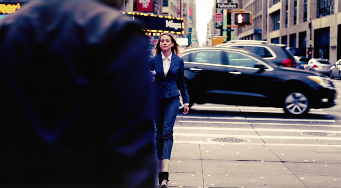 Cinematic‑realistic medium shot. A field reporter stands on a busy city sidewalk, holding a microphone and delivering a short spoken line. Cars pass behind her, pedestrians move through frame, and neon signs flicker. The camera holds steady with a slight forward push. She speaks with crisp clarity: "Live on scene, we're taking a quick look at how well this model handles real‑world audio." Ambient audio includes traffic hum, footsteps, and distant horns mixed naturally beneath her voice.